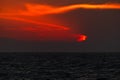 Beautiful colorful sunset at ocean with dramatic clouds and mountains Royalty Free Stock Photo