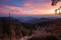Beautiful colorful sunset over a hazy mountainous landscape. Layers of dreamy hills fading into the distance Royalty Free Stock Photo