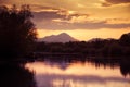 A beautiful, colorful sunset over the mountains, lake and forest in purple tones. Abstract, bright landscape. Royalty Free Stock Photo