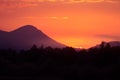 A beautiful, colorful sunset over the mountains, lake and forest in purple tones. Abstract, bright landscape. Royalty Free Stock Photo