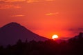 A beautiful, colorful sunset over the mountains, lake and forest in purple tones. Abstract, bright landscape. Royalty Free Stock Photo