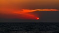 Beautiful colorful sunset at sea with dramatic clouds and mountains Royalty Free Stock Photo