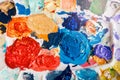 Beautiful colorful textured paints background. Paint strokes and left overs residues of paints in palette colour array Royalty Free Stock Photo