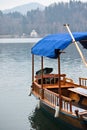 Beautiful colorful traditional rowing wooden boat pletna on pure lake bled