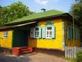 Beautiful colorful ukrainian village house exterior with red porch and green, white windows with shutters