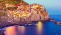Beautiful colorful view of village Manarola by night in Cinque Terre, Italy Royalty Free Stock Photo