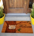 Beautiful Colorful Welcome zute doormat with Tree and Night Owl outside home with yellow flowers and leaves Royalty Free Stock Photo