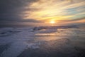 Beautiful winter landscape with frozen lake and sunset Royalty Free Stock Photo