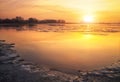 Beautiful colorful winter landscape with frozen lake and sunset Royalty Free Stock Photo