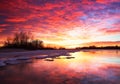 Beautiful colorful winter landscape with frozen lake and sunset Royalty Free Stock Photo