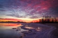 Beautiful colorful winter landscape with frozen lake and sunset Royalty Free Stock Photo