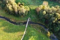Beautiful colors of autumn. Forest, meadow and river with bridge photographed with a drone on sunny day. Royalty Free Stock Photo