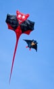 A beautiful, colourful stunt kite, in the blue sky, high up in the wind in form of devil Royalty Free Stock Photo