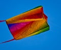A beautiful, colourful stunt kite, in the blue sky, high up in the wind Royalty Free Stock Photo
