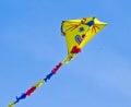 A beautiful, colourful stunt kite, in the blue sky, high up in the wind Royalty Free Stock Photo