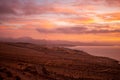 Beautiful colourful sunset above Atlantic ocean and coast, horizon over water, Playa de sotavento, Fuerteventura, Spain