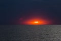 Beautiful colourful sunset evening over the Black sea with big dark waves, Kinburn Foreland shore, Ukraine