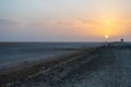 Beautiful colourful sunset over endless empty road in middle of desert. Asphalt highway in Tunisia, North Africa.