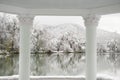 Beautiful columns on a background of lake and winter park