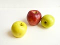 A beautiful combination of yellow, green and red apples on a white background