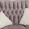 Beautiful, comfortable grey sofa with soft, light grey cushions, forms part of the interior furniture in the living room, closrup