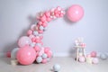 Beautiful composition with balloons and sweets near light wall Royalty Free Stock Photo