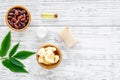 Beautiful composition with cocoa butter cosmetics. Cocoa butter and cocoa beans near homemade soap, cream, oil or lotion Royalty Free Stock Photo