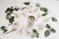 Beautiful composition with cup of matcha tea and flowers on white background. Flatlay, top view Royalty Free Stock Photo