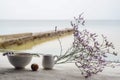 Beautiful composition of mountain lavender flowers and delicious lunch, hot soup in a white plate, a small vessel with sour cream Royalty Free Stock Photo