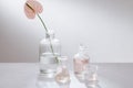 Beautiful composition with perfume samples and flowers on table