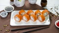 Sushi rolls on white plate with salmon