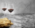 A beautiful composition - two glasses with red wine and Jewish matzah bread. Light gray background. Empty space to insert. Royalty Free Stock Photo