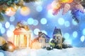 Beautiful composition with vintage Christmas lantern and festive decorations on snow against color background. Bokeh effect Royalty Free Stock Photo