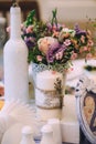 Beautiful composition on the wedding table in the style of Provence. White candle decorated with lavender, a bouquet of flowers, a Royalty Free Stock Photo