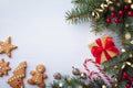 Beautiful composition on white background with golden Christmas gift boxes, fir tree, Christmas cookies and holiday decoration.