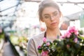 Beautiful concentrated woman florist working with flowers