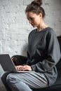 beautiful concentrated woman in grey clothes