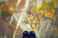 Beautiful concept for summer travel. Small children's shoes on the world map. Planning a summer vacation and holidays. Royalty Free Stock Photo