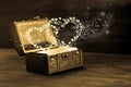 Beautiful concept of vintage chest with light heart miracle on w