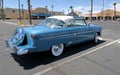 Light blue and white 1950s Ford Crestline in parking lot - rear passenger side view