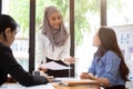 A beautiful Asian Muslim female leader is discussing with her team in the meeting Royalty Free Stock Photo