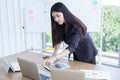 beautiful Confident asian young business woman working and pointing laptop computer with tablet and document file graph on desk Royalty Free Stock Photo