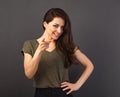 Beautiful confident excited smiling business woman showing the finger on camera maiking the choice on grey background with empty Royalty Free Stock Photo