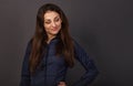 Beautiful confident thinking smiling business woman with folded arms, long brown hair in blue shirt on grey background looking Royalty Free Stock Photo