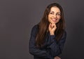 Beautiful confident thinking smiling business woman with folded arms looking up in blue shirt on grey background with empty copy Royalty Free Stock Photo