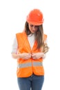 Beautiful construction worker girl buttoning her vest