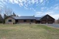 Beautiful contemporary rustic log cabin on a rural field in the mountains