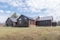 Beautiful contemporary rustic log cabin on a rural field in the mountains