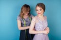 Beautiful coordinator woman button up a bride wedding dress in the studio on a blue background