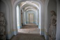 A beautiful corridor with statues in an old abandoned manor house. Royalty Free Stock Photo